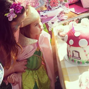 Birthday girl blowing out the candles with Angelina Sparkle Fairy 