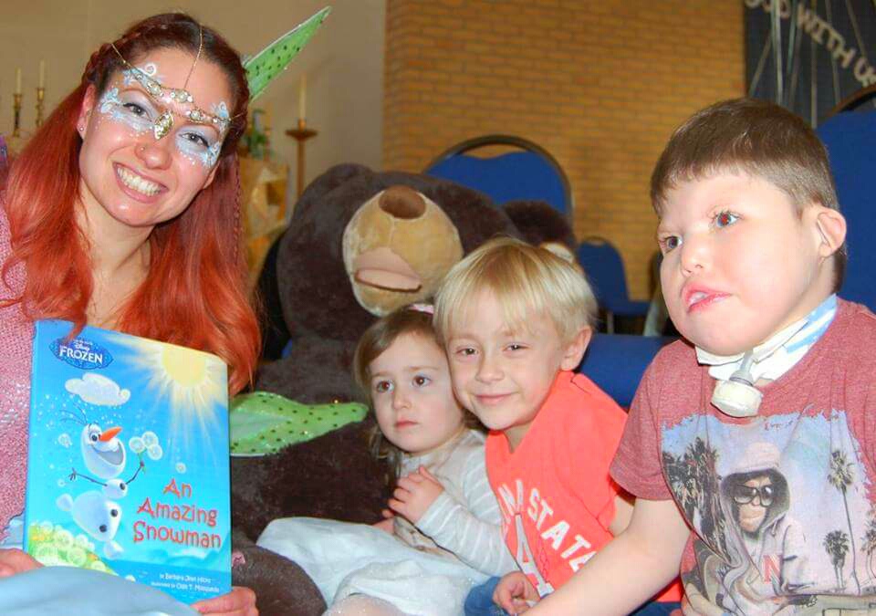 Viola Fairy reads to children from Julia\'s House